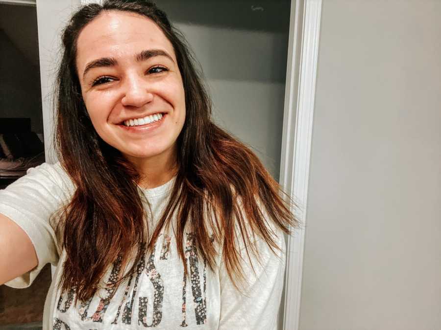 Young woman taking a smiling selfie