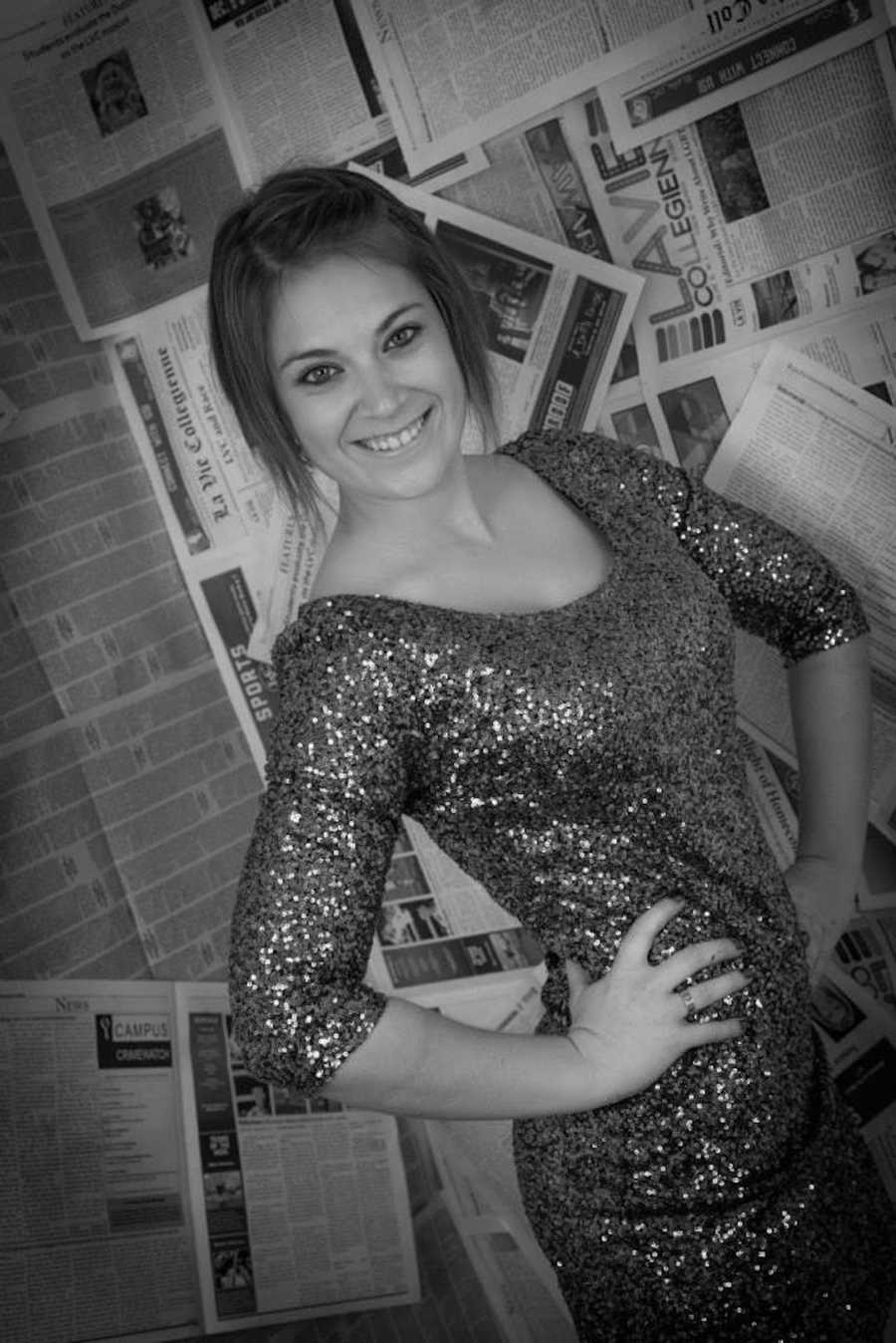 Black and white photo of smiling girl wearing sparkly shirt in