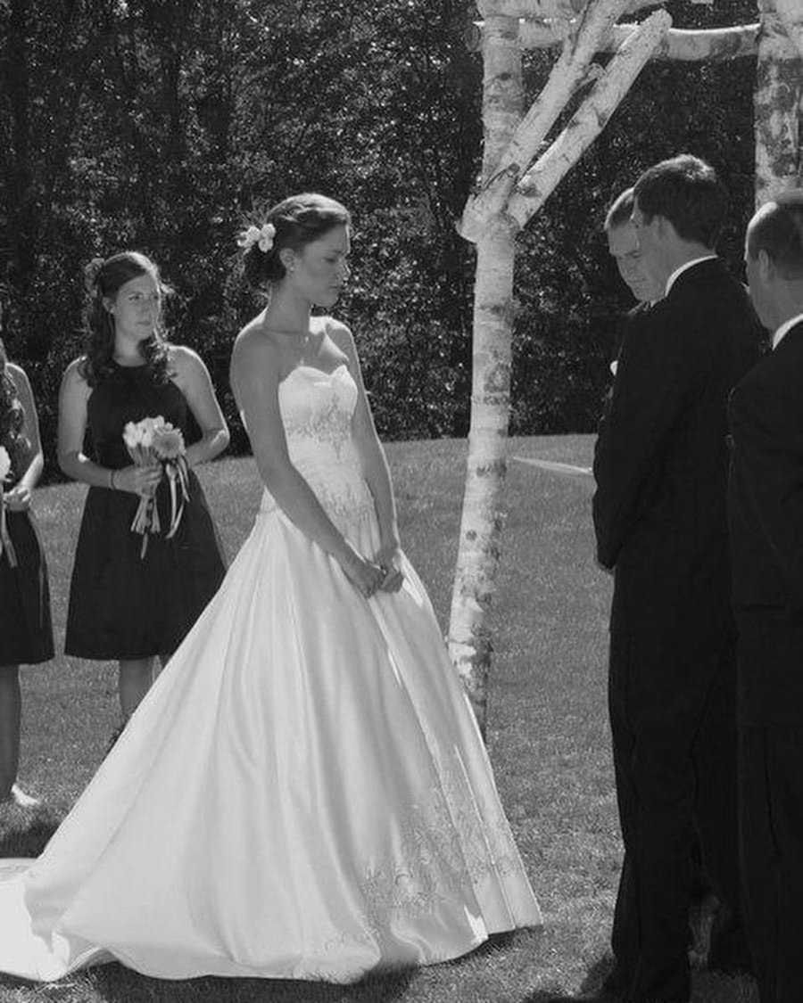 Bride and groom at wedding standing under altar