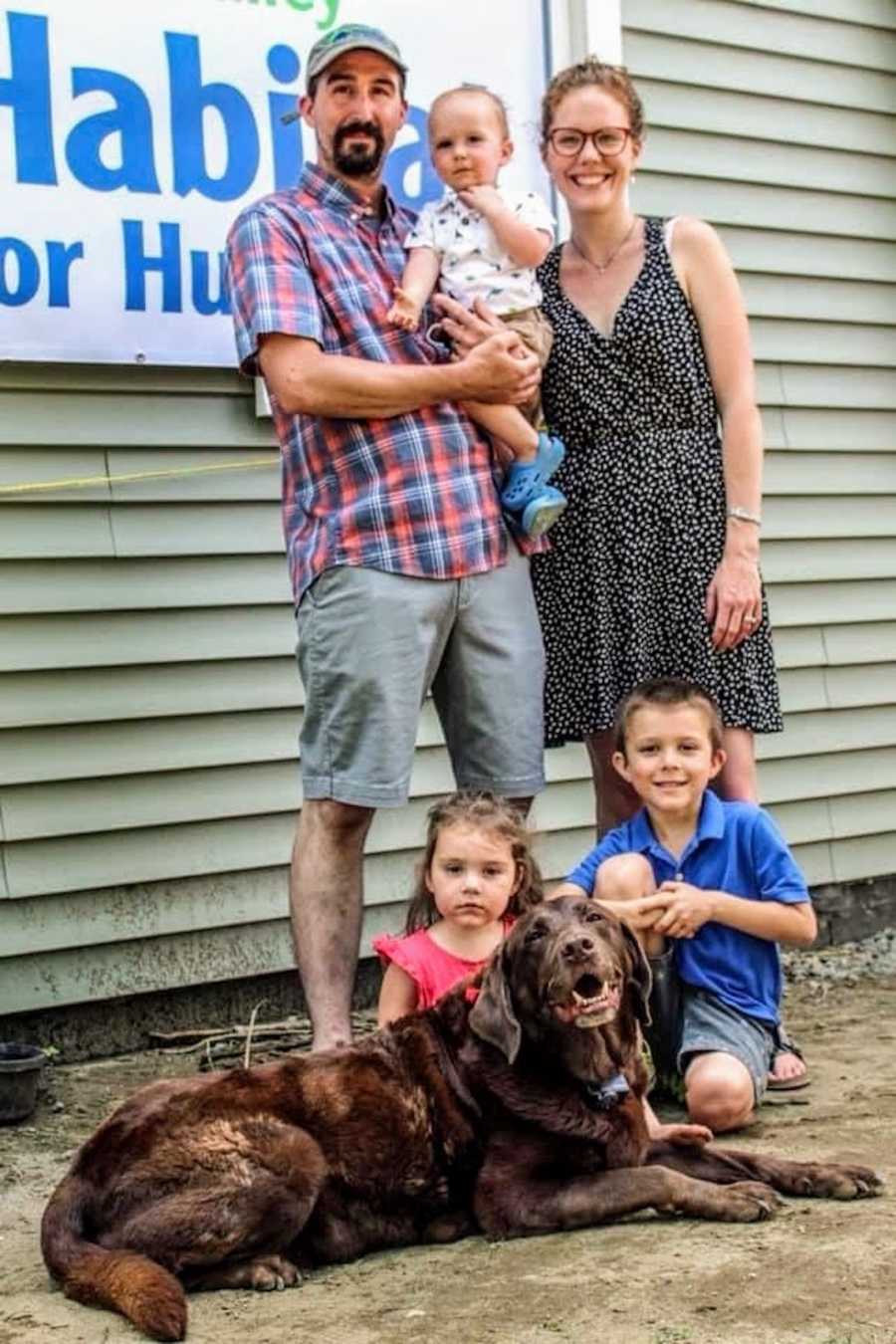 Family of five photo with chocolate lab lying at feet