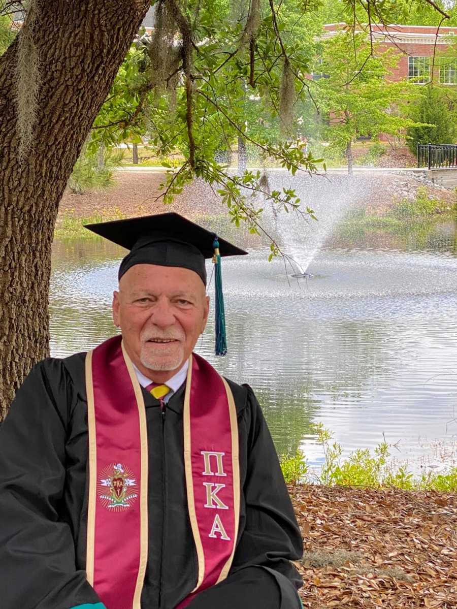 An older college graduate in cap and gown