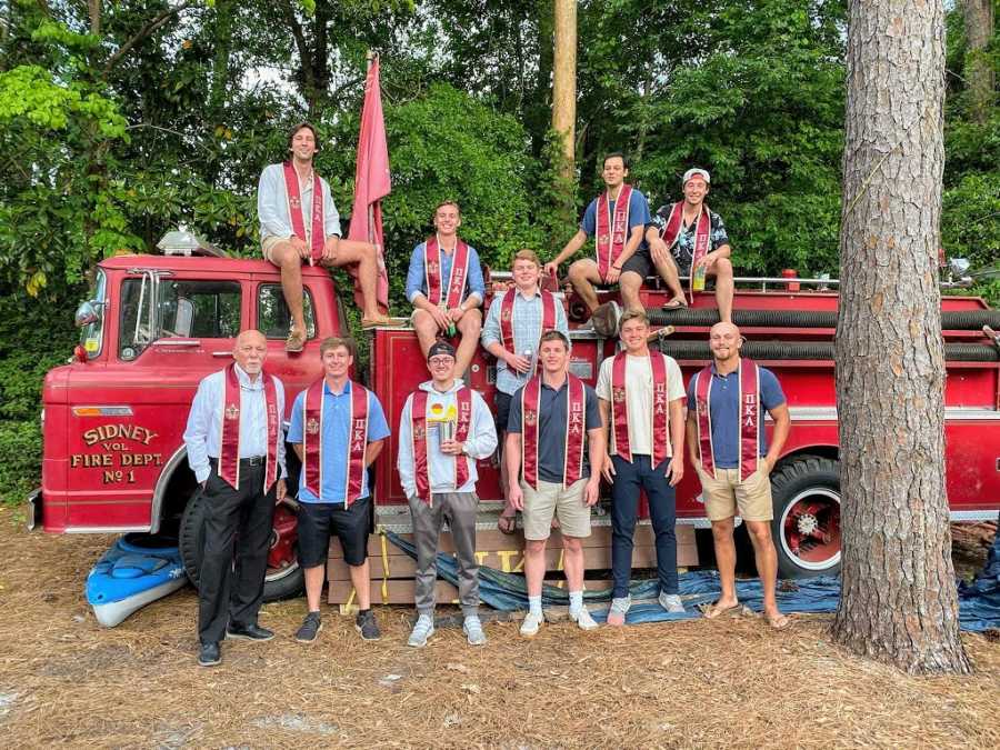 A nontraditional college student with the members of his fraternity