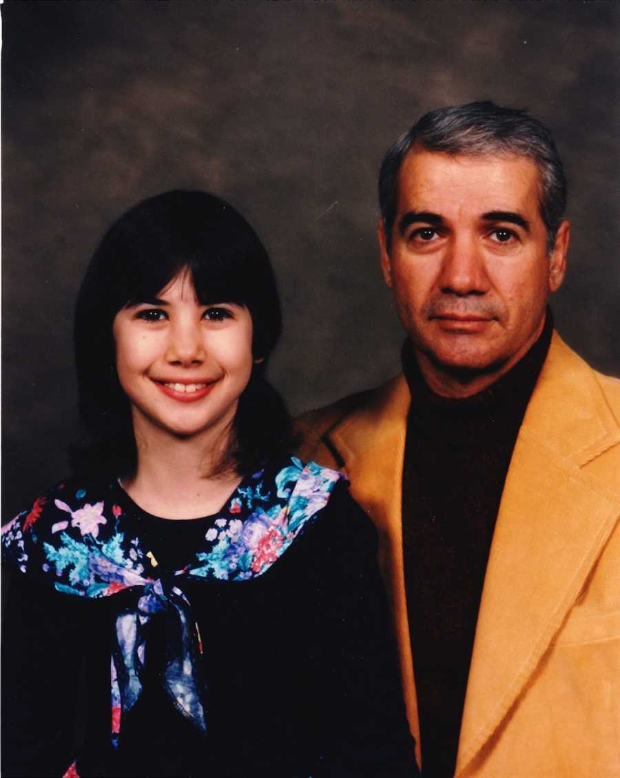 Young girl smiling with her father, not smiling