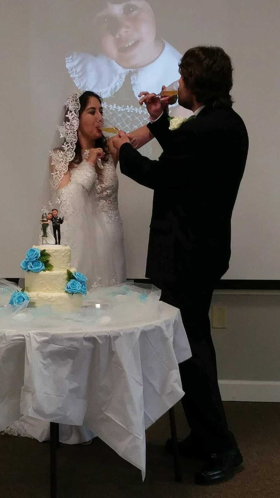 Young woman in wedding dress standing with young man in suit