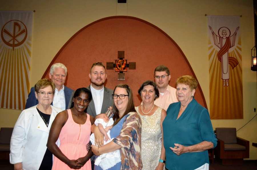 An Indian transracial adoptee stands with her family in a church