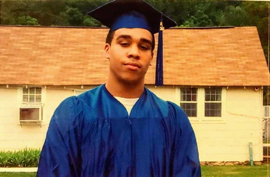 A teenage adoptee wearing a blue cap and gown