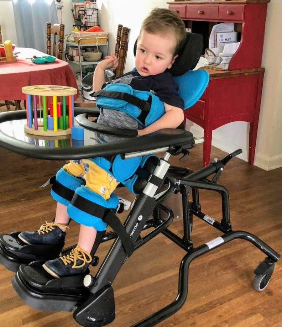 A 2-year-old boy in a vertical wheelchair