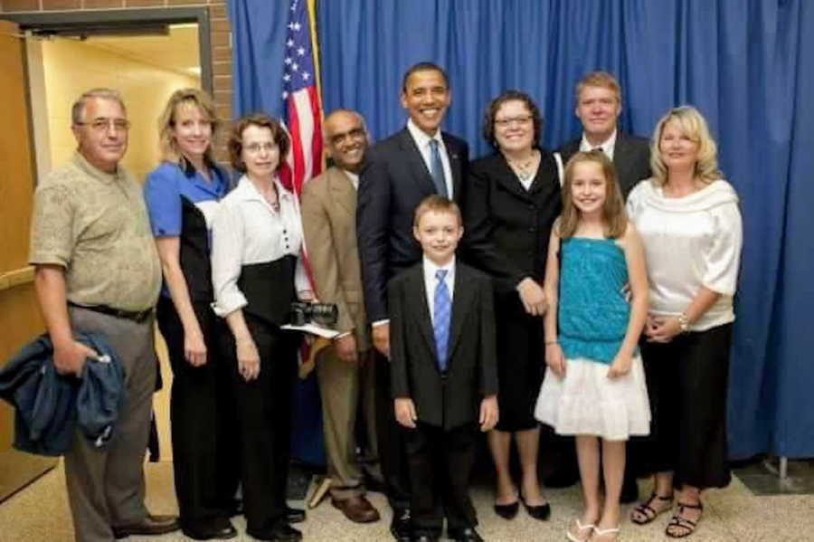 Group of people standing with President Obama