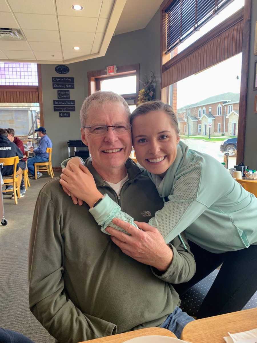 Father and daughter hugging and smiling