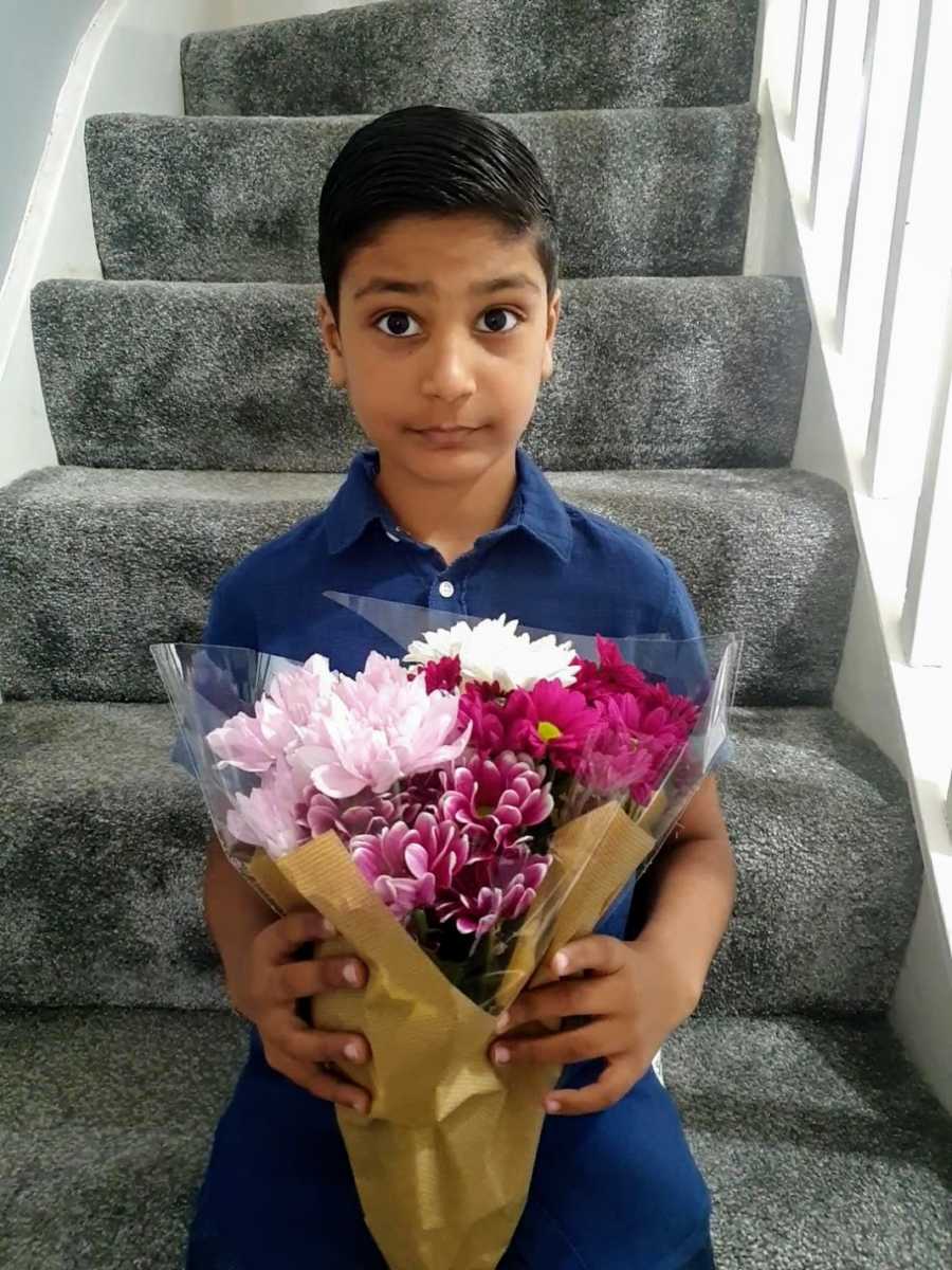 A boy with nonverbal autism holding flowers