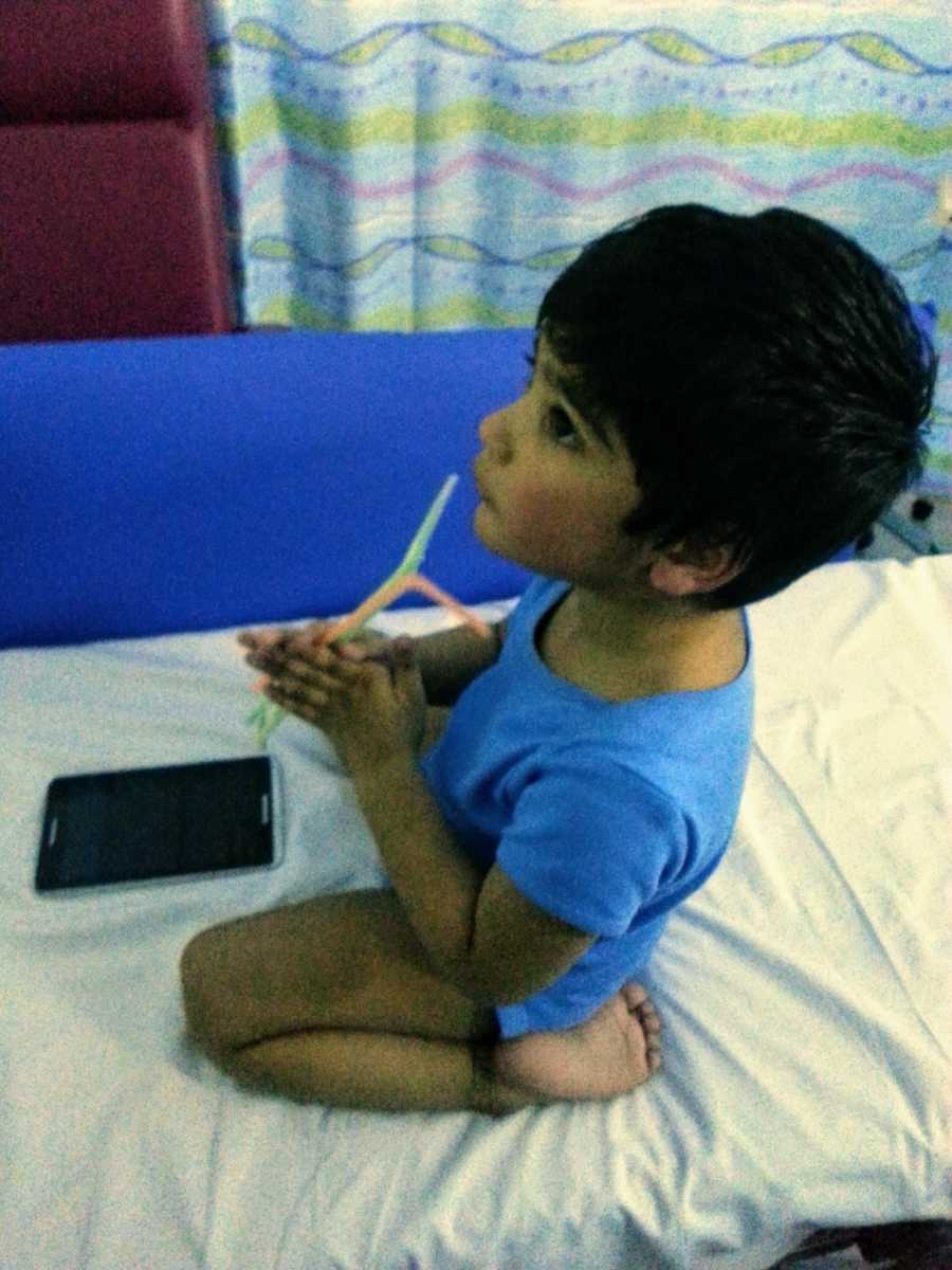 A boy with nonverbal autism playing with straws