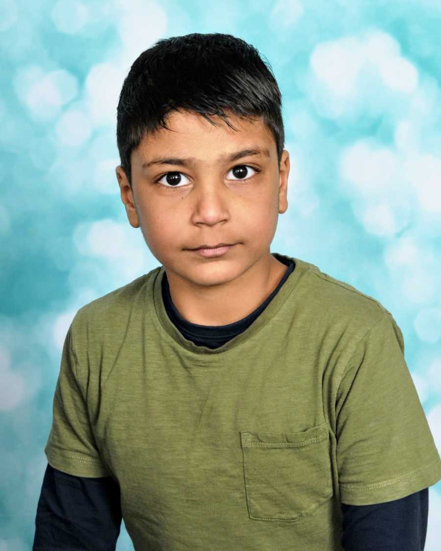 A boy with nonverbal autism wearing a green shirt