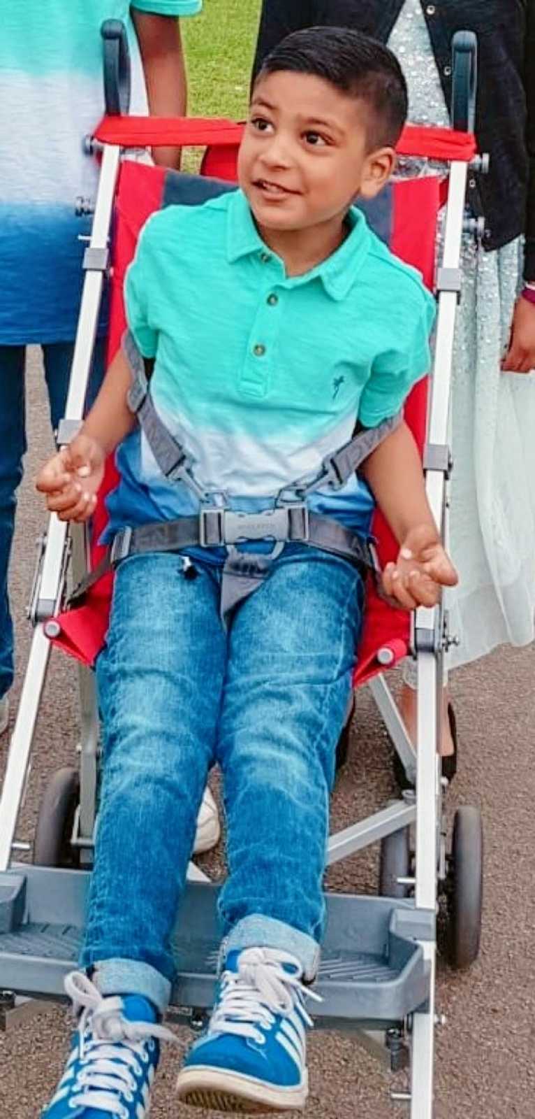 A boy with nonverbal autism sits in a stroller