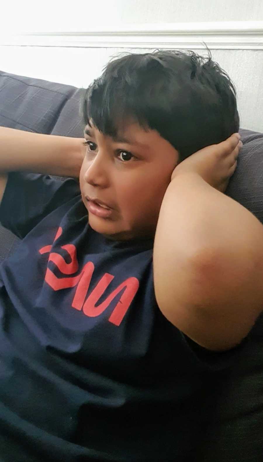 A boy with nonverbal autism covers his ears