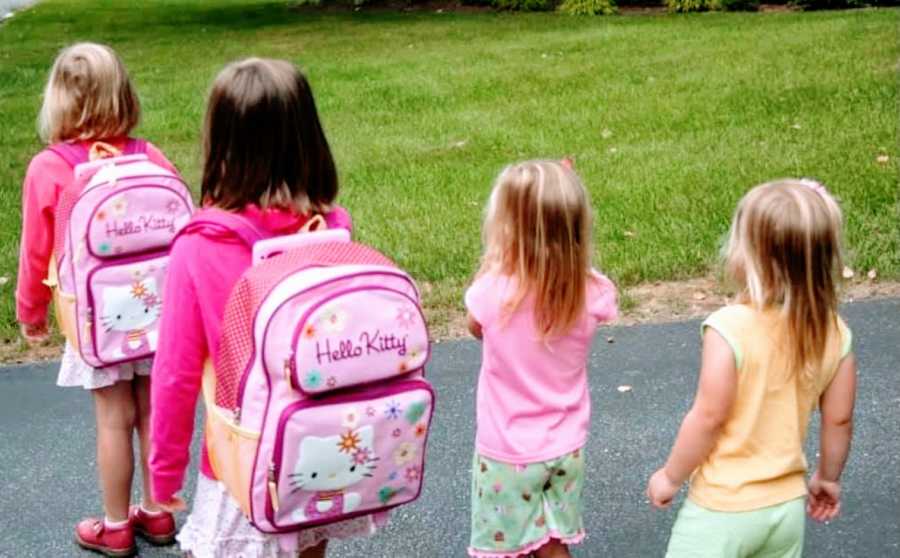 Mom takes a photo of her four daughters while walking them to the bus stop