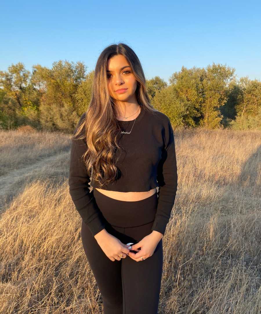 girl standing outside in field