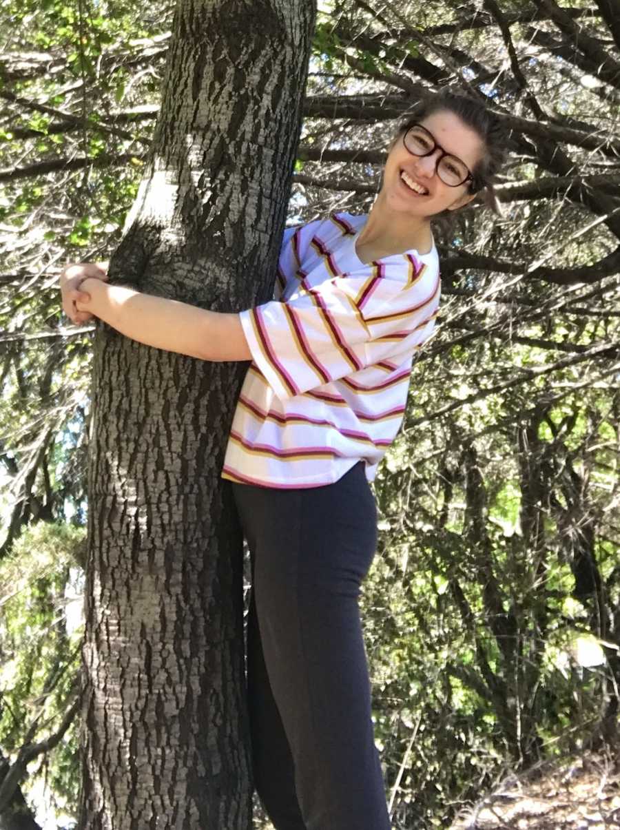 girl holding a tree