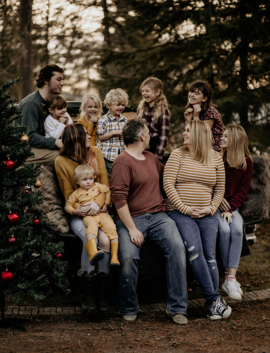 family of 10 posing outside