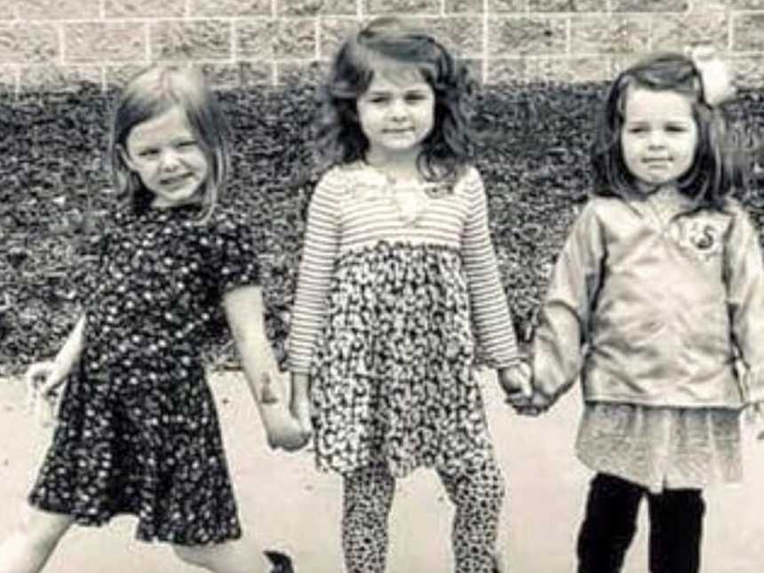 三个坚强自信的姐妹一起拍了一张时髦的照片