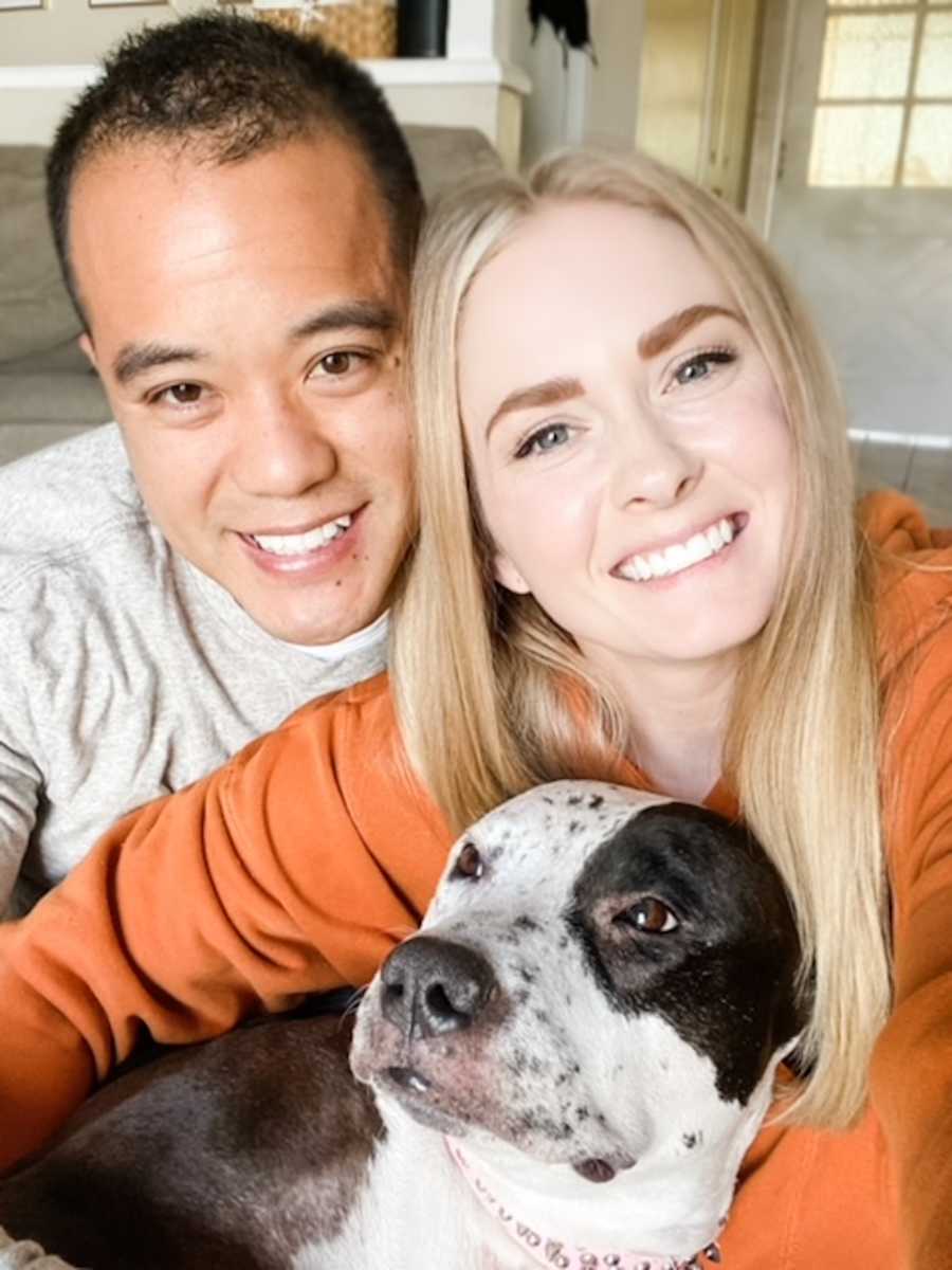 couple smiling with dog