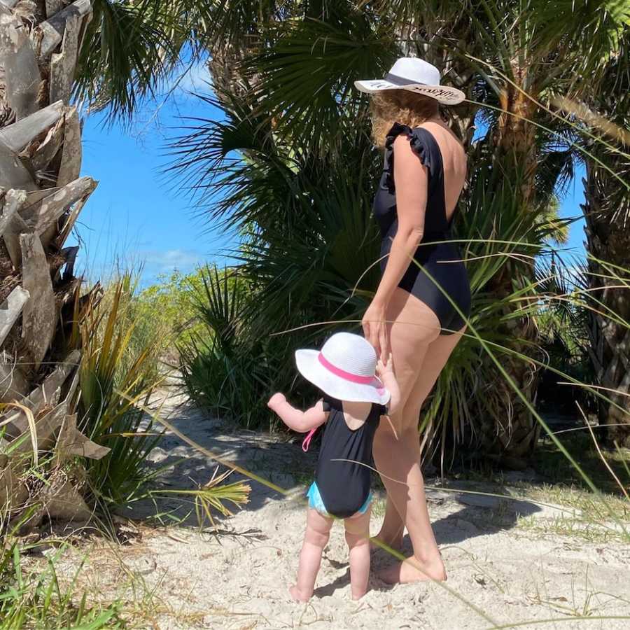 Mom and daughter exploring the beach