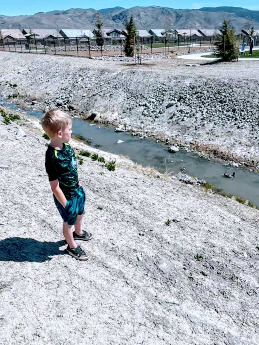 Young boy with hidden disability takes a moment to appreciate the view