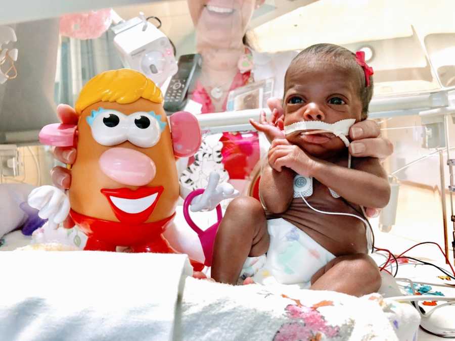 Nurse takes photo of preemie baby next to Potato Head figure to show size difference