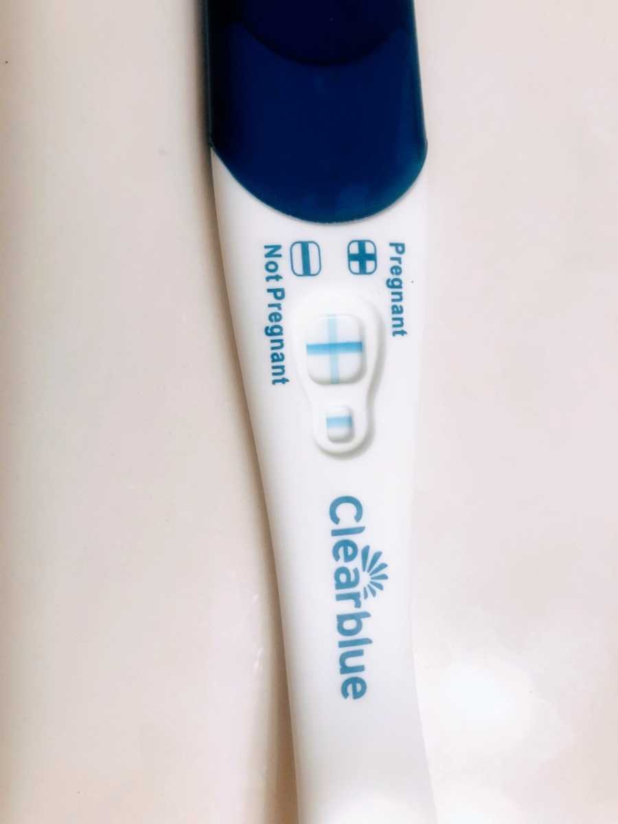 Expecting mother takes a photo of her positive Clearblue pregnancy test