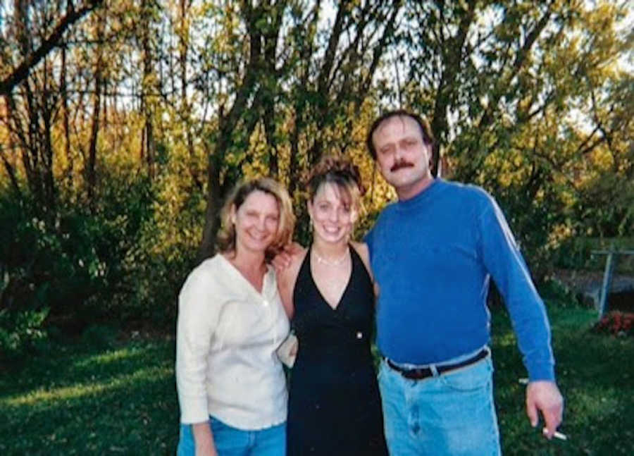 Mother and father with arms around daughter before she goes to a formal dance
