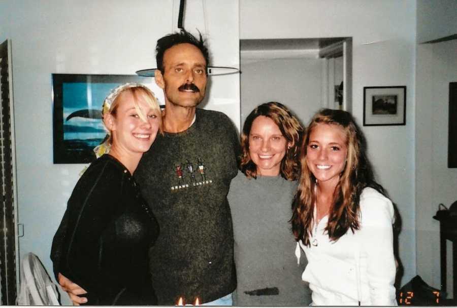 Family of four with arms around dad at his birthday party