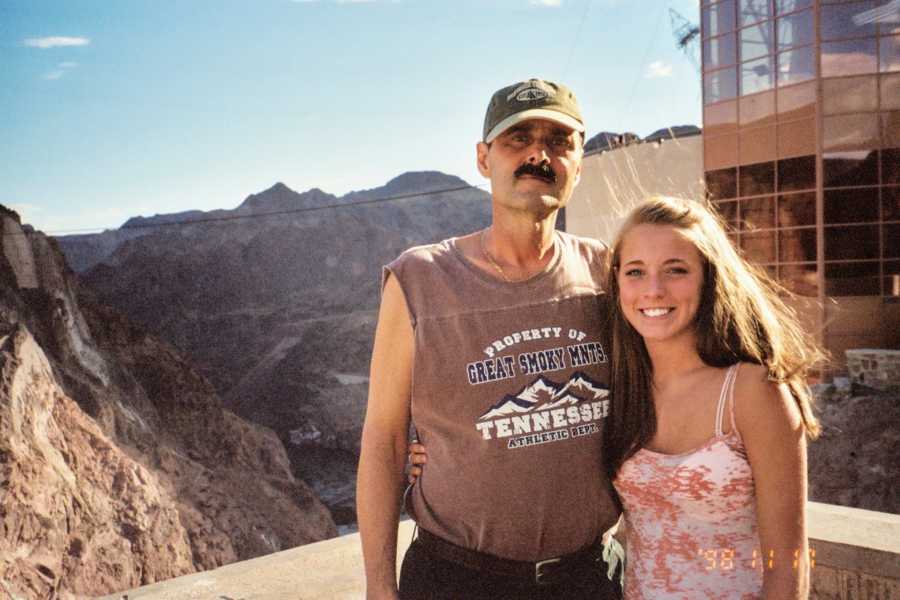 Father and daughter with arms around each other at national park