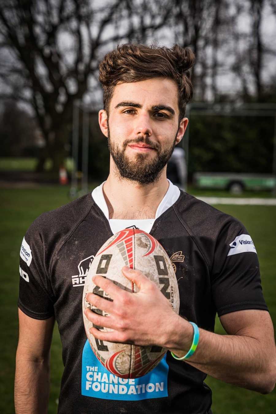 Man posing with football