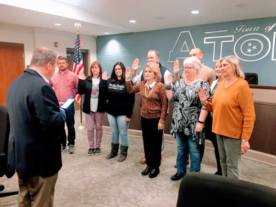 Woman being sworn into office on her local town's committee