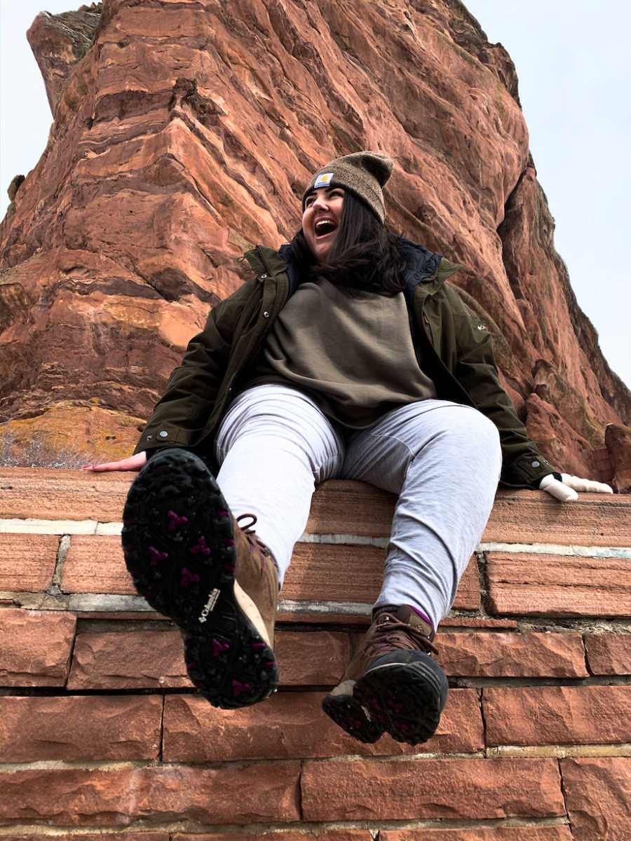 Woman posing at rock formation