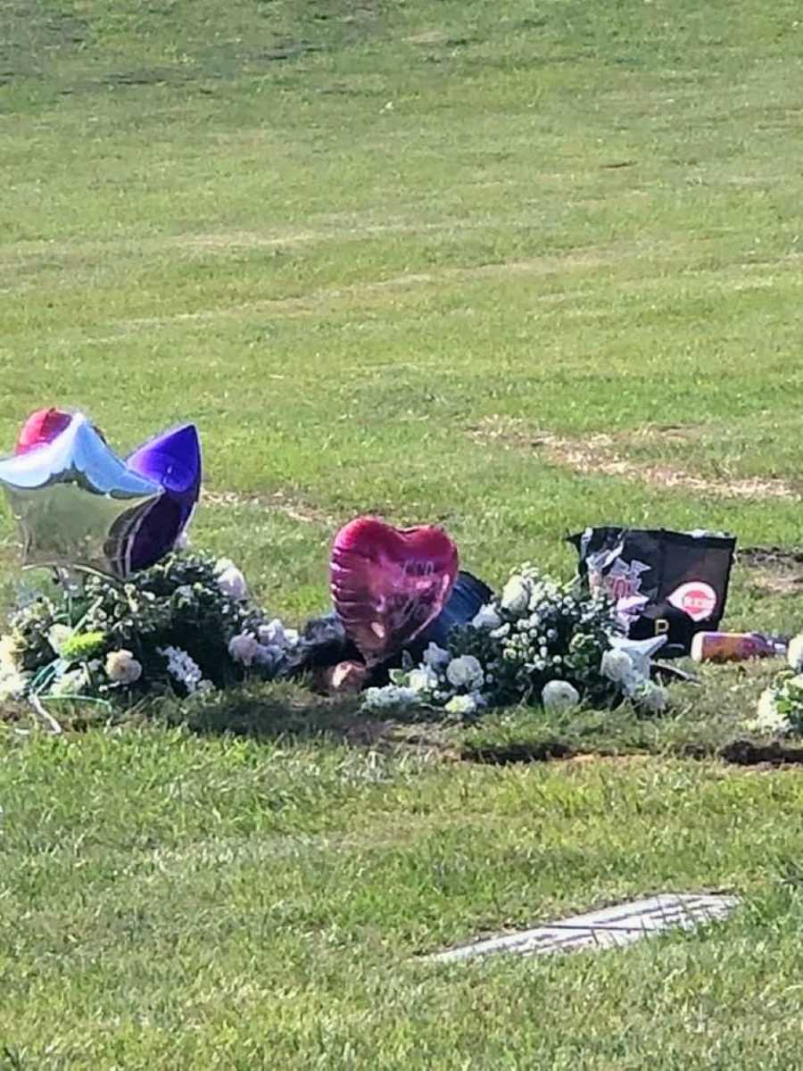 Woman lays down at her boyfriend's grave and cries