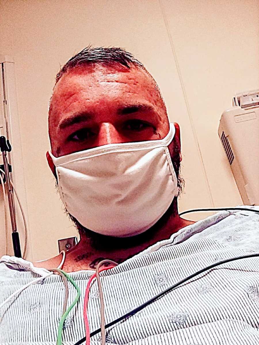 Man recovering from a violent attack takes a selfie in the hospital with a mask on