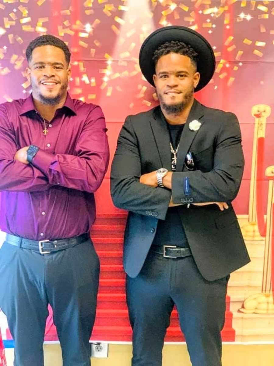 Twin brothers pose for a photo together dressed up in church attire