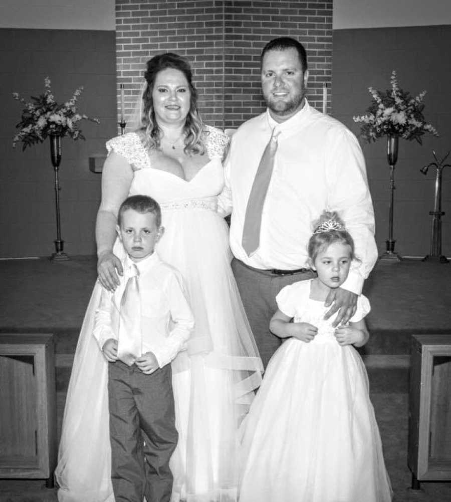 Newly weds take a photo with their two children before their wedding reception