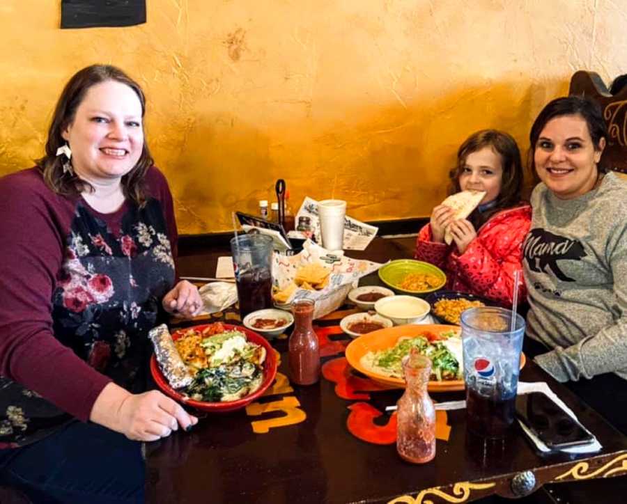 Two moms enjoy a nice lunch out together with some of their children