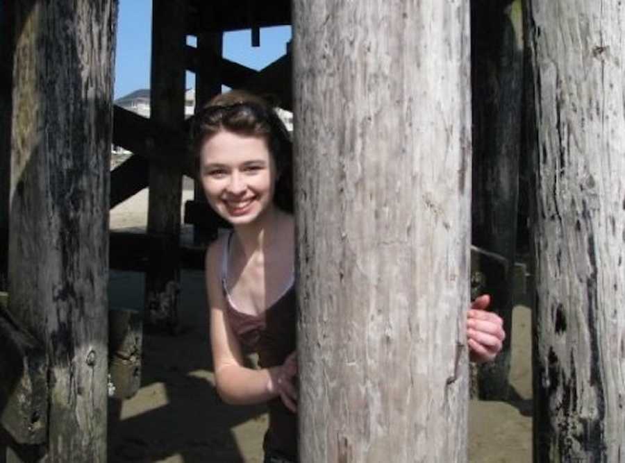 girl posing by a tree