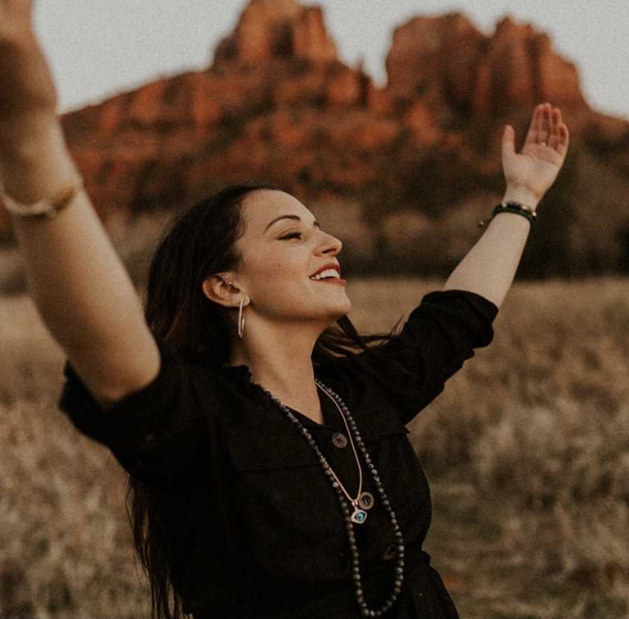 Woman raising hands in happiness