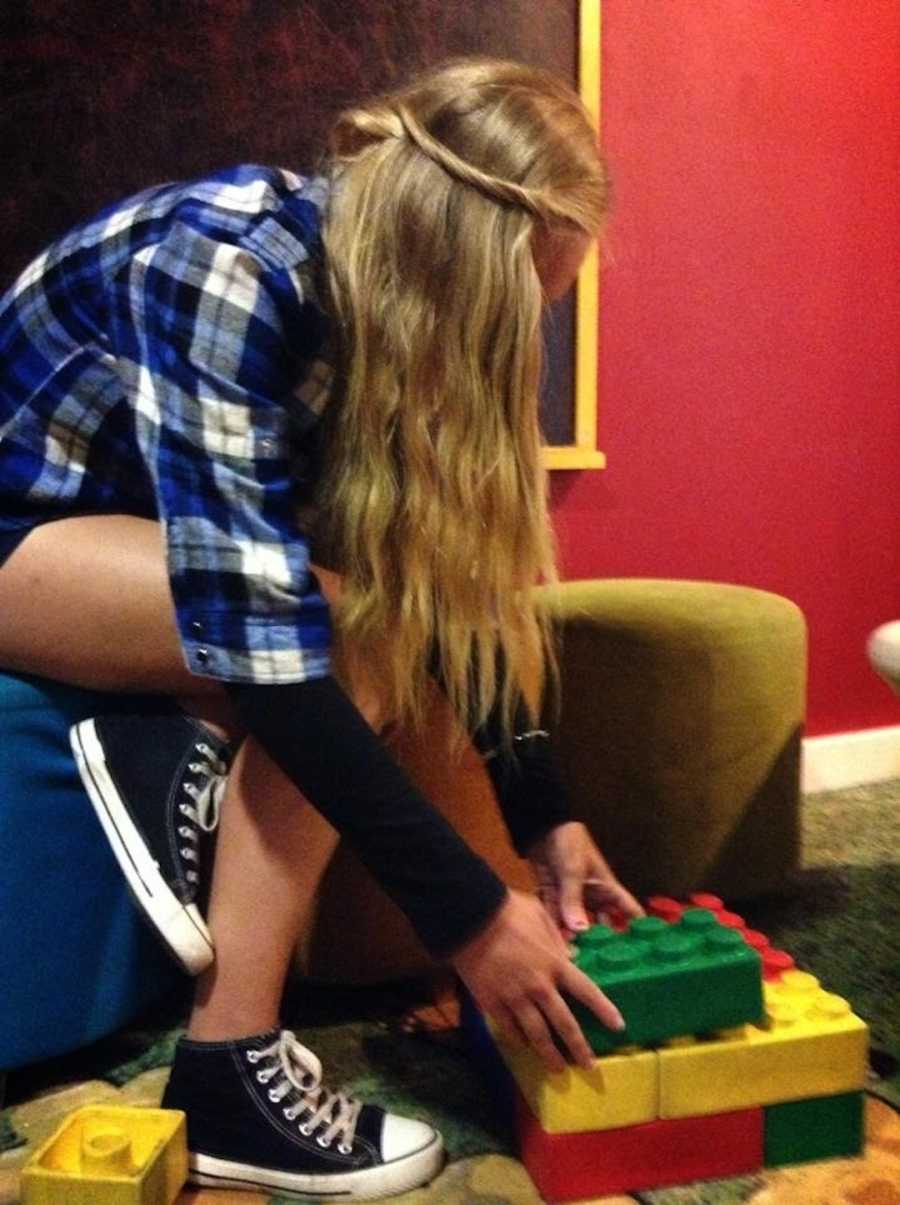 girl building with legos