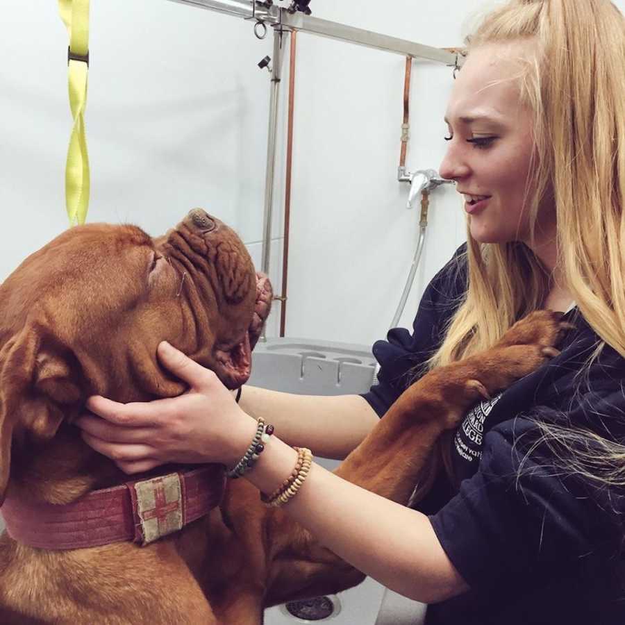 girl hugging a dog