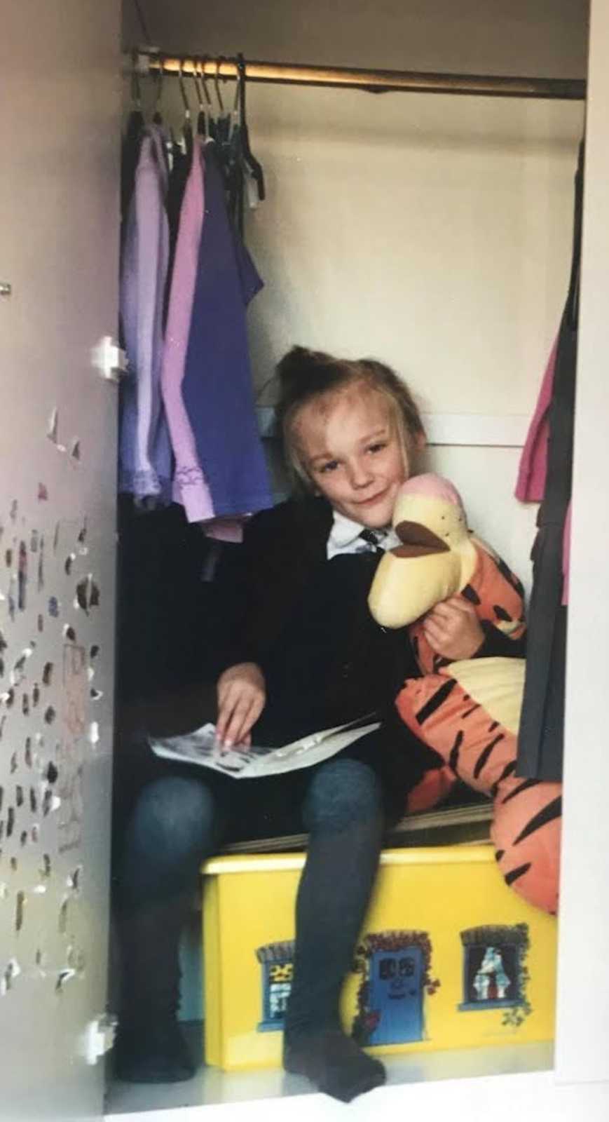 young girl in a closet
