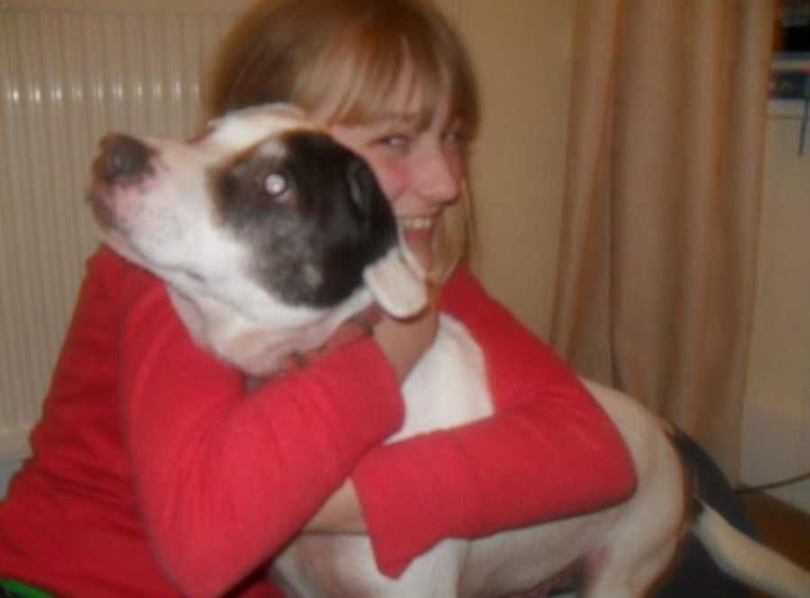 teenaged girl hugging a dog