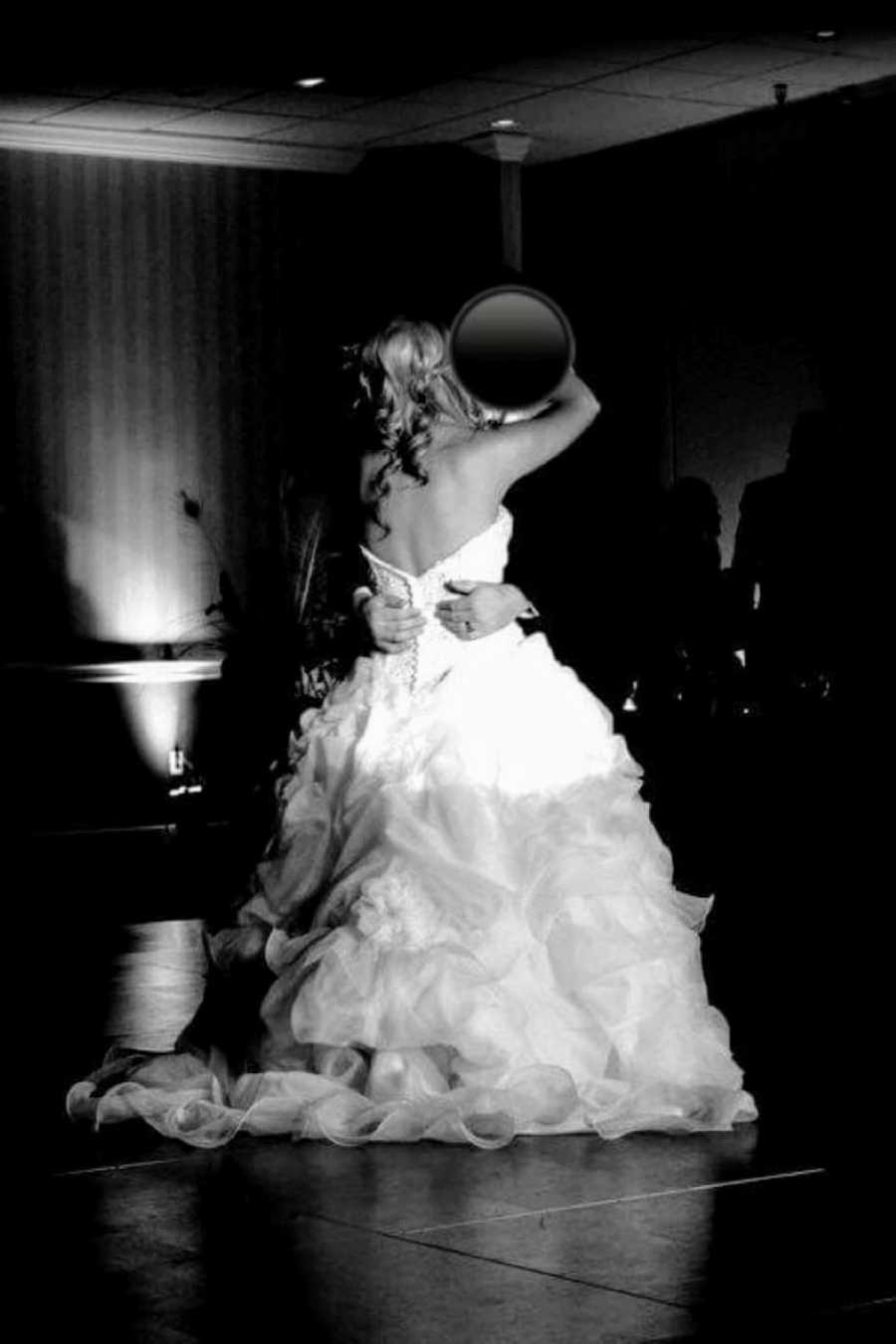 Newly weds share a sweet moment during their first dance at their wedding reception