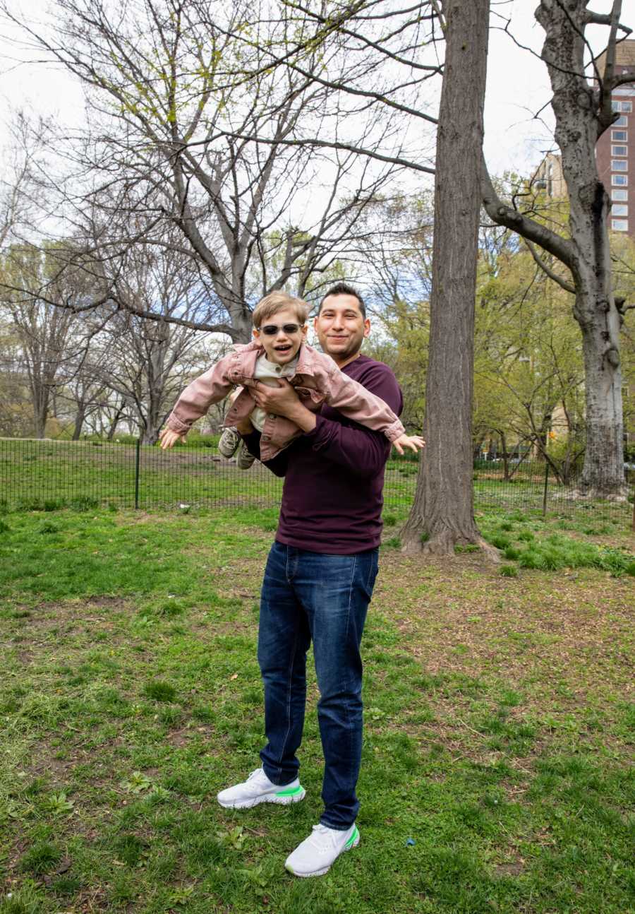 Dad plays with his son born with CMT while taking family photos at the park