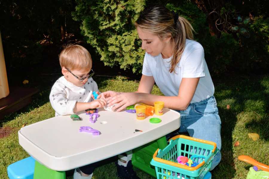 Mom sits outside and plays with her son who has CMT