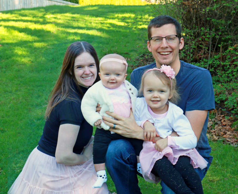 couple with two kids sitting outside