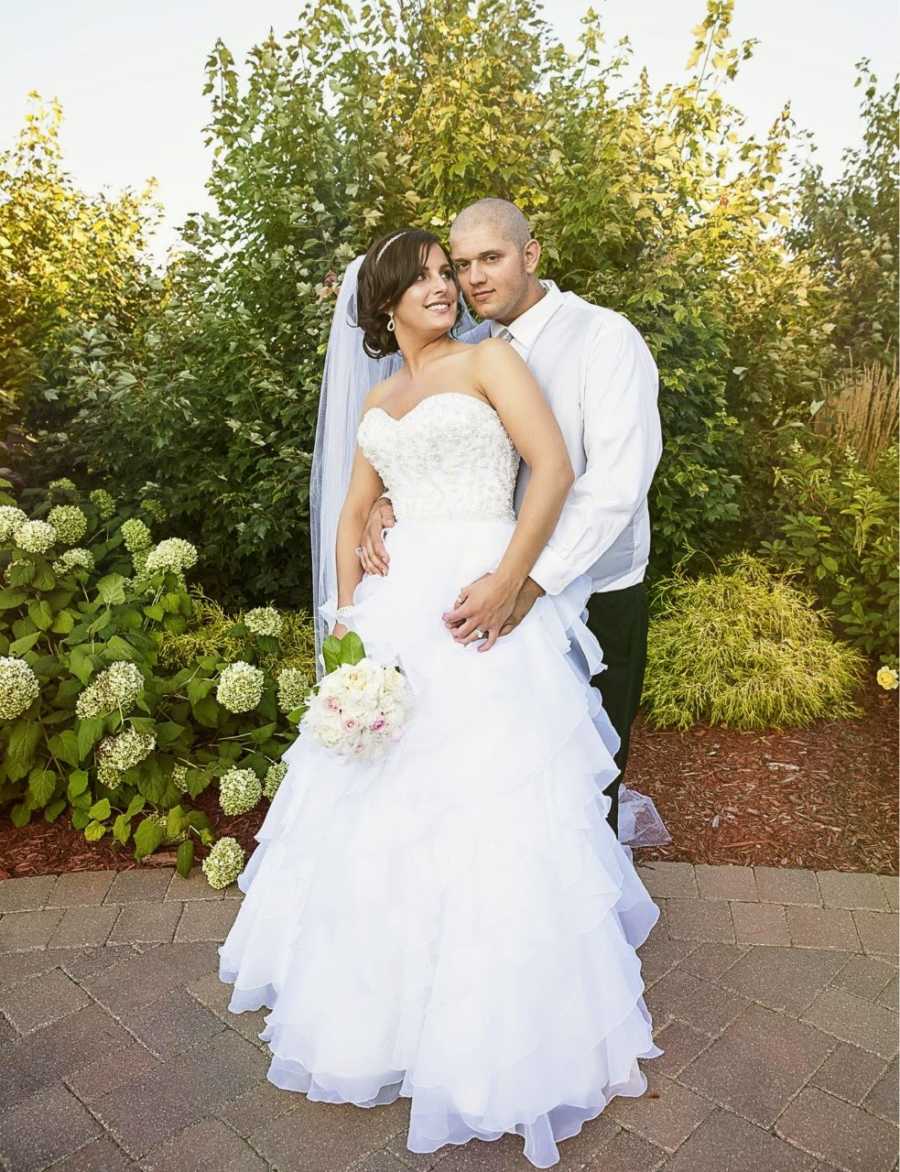 Young couple pose for a photo during their wedding day